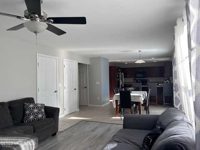 living room with light wood-style flooring and baseboards