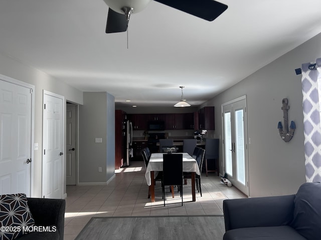 dining room featuring light tile patterned floors and baseboards