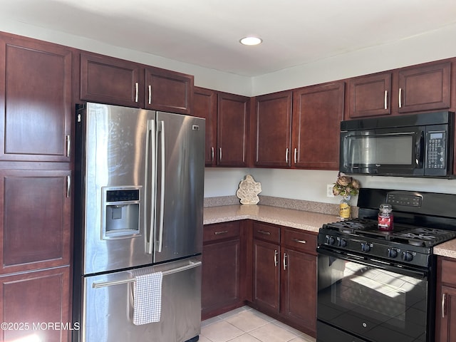 kitchen with black appliances, light tile patterned floors, light countertops, and recessed lighting