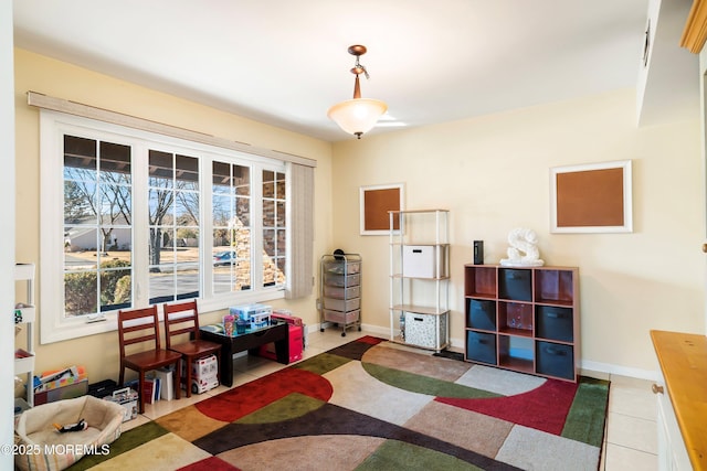 recreation room with tile patterned floors and baseboards