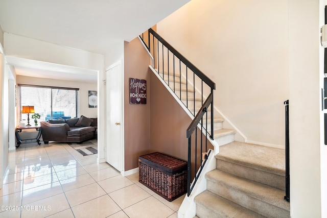 staircase featuring tile patterned flooring and baseboards