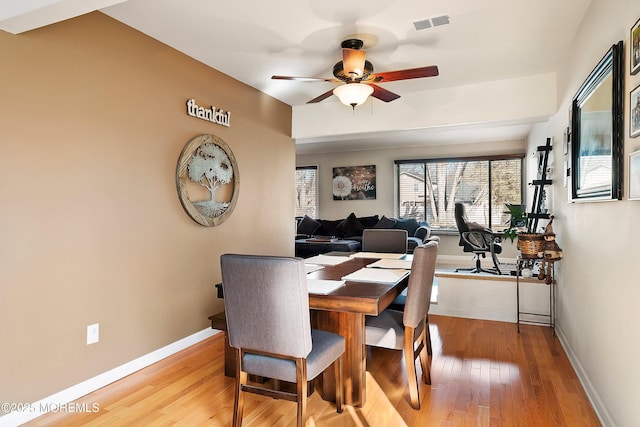 dining area featuring visible vents, ceiling fan, baseboards, and hardwood / wood-style floors