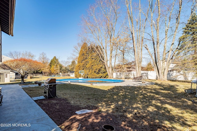 view of yard with a fenced in pool, a patio, and fence