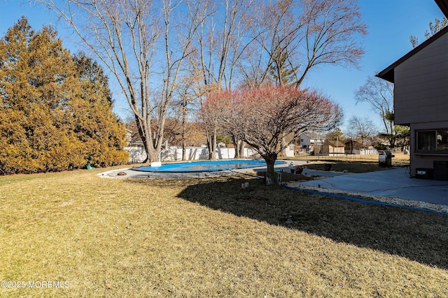 view of yard featuring a fenced in pool and fence