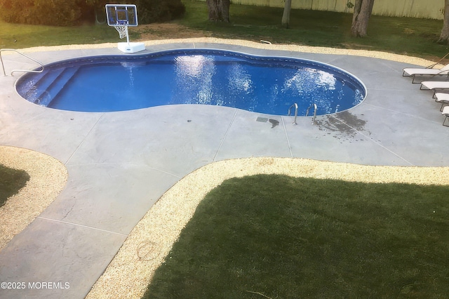 outdoor pool with a patio area