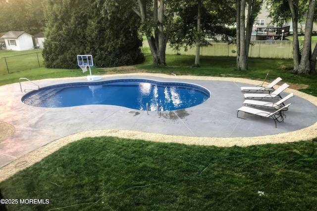 view of swimming pool with a fenced in pool, a yard, a patio area, and fence