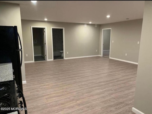 interior space with recessed lighting, baseboards, and wood finished floors