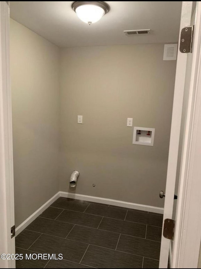 clothes washing area featuring laundry area, visible vents, baseboards, hookup for a gas dryer, and washer hookup