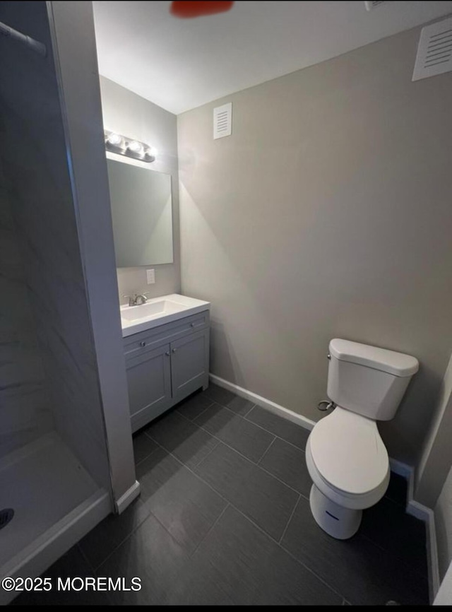 bathroom with visible vents, baseboards, toilet, vanity, and a shower stall