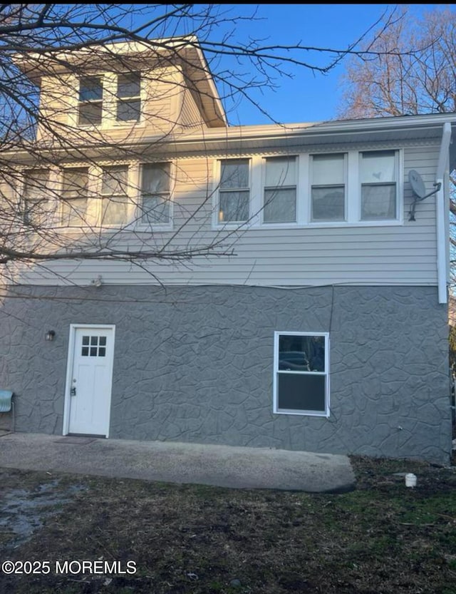 view of side of property featuring stucco siding