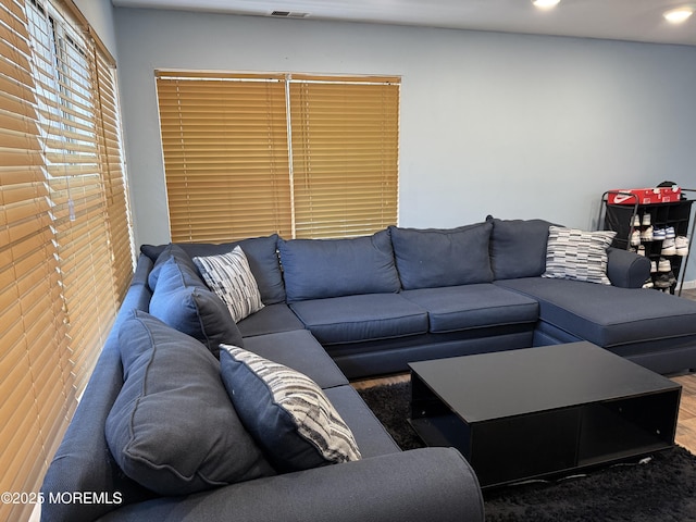 living area featuring visible vents and recessed lighting