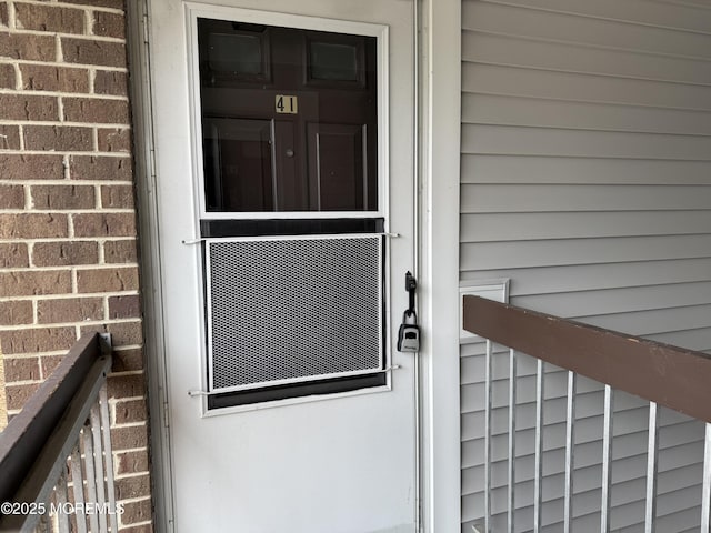 property entrance with brick siding