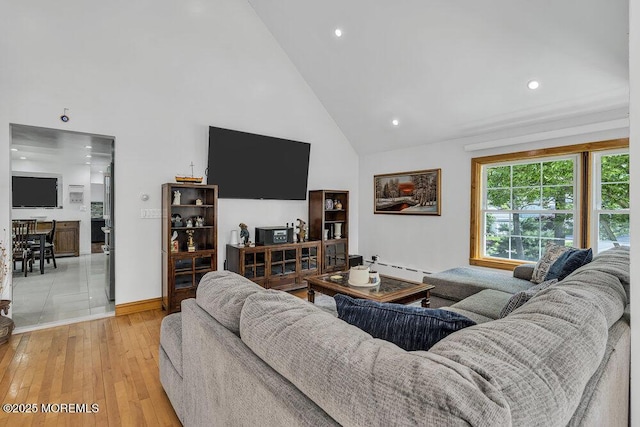 136 Van Brackle Rd, Matawan, NJ 07747 - living room with high vaulted ceiling, light wood-style flooring, baseboard heating, recessed lighting, and baseboards