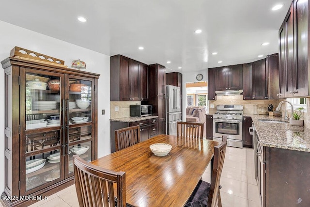 136 Van Brackle Rd, Matawan, NJ 07747 - kitchen with stainless steel appliances, light tile patterned floors, a sink, dark brown cabinets, and recessed lighting