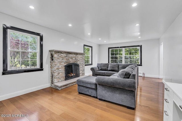 136 Van Brackle Rd, Matawan, NJ 07747 - living area with light wood finished floors, a fireplace, recessed lighting, baseboards, and a baseboard radiator