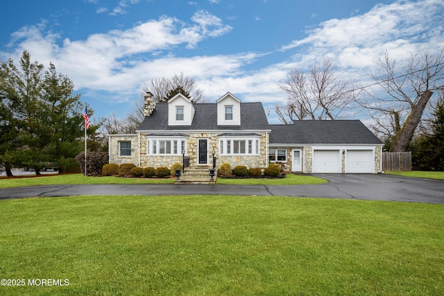 cape cod home featuring a garage, stone siding, aphalt driveway, fence, and a front lawn