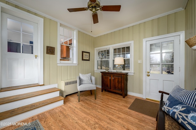 interior space featuring radiator heating unit and a ceiling fan
