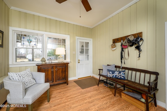 interior space with ceiling fan, light wood-style floors, baseboards, and crown molding