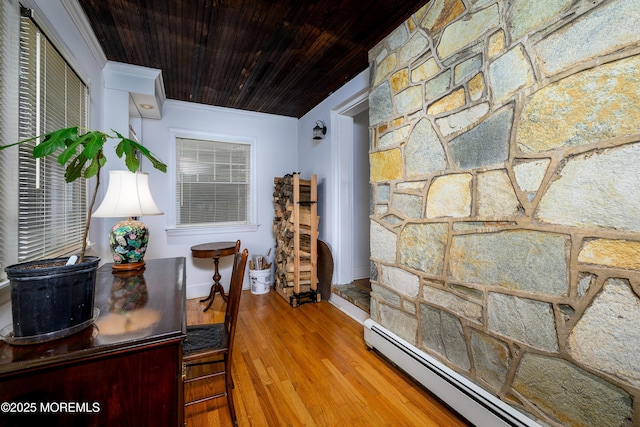 dining space featuring baseboards, wood ceiling, ornamental molding, wood finished floors, and baseboard heating