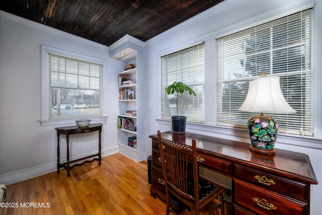 home office featuring baseboards, wooden ceiling, wood finished floors, crown molding, and built in shelves