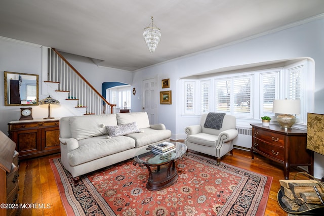 living area with ornamental molding, hardwood / wood-style floors, and radiator