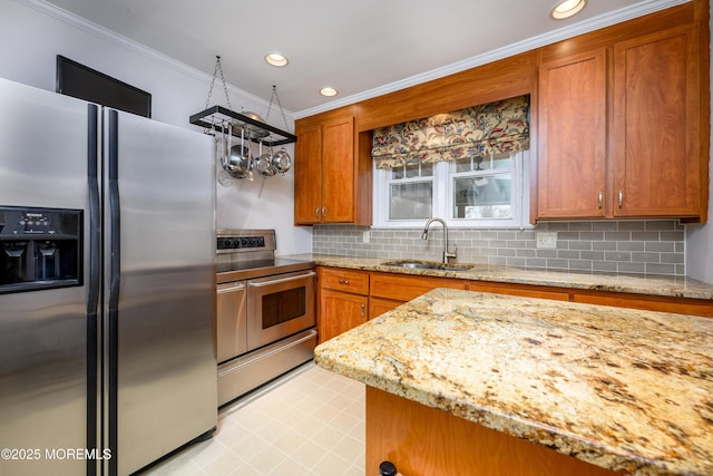 kitchen featuring brown cabinets, crown molding, tasteful backsplash, appliances with stainless steel finishes, and a sink
