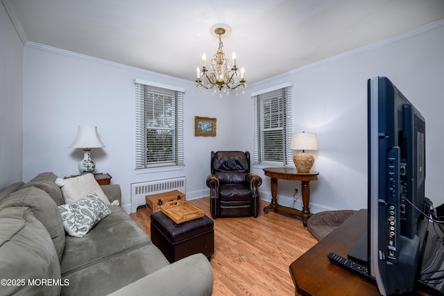 living room featuring baseboards, radiator heating unit, wood finished floors, crown molding, and a chandelier