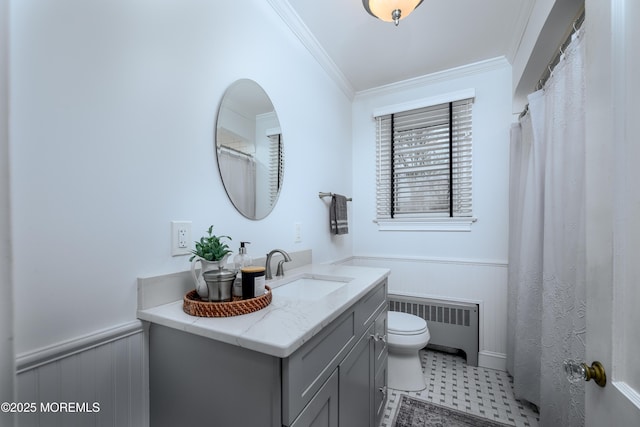 bathroom featuring toilet, a wainscoted wall, vanity, radiator, and crown molding