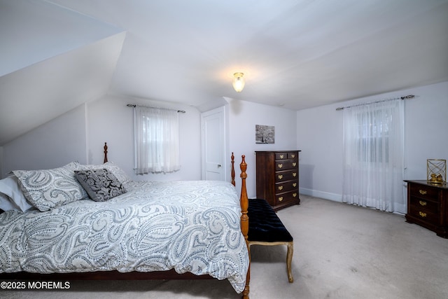 bedroom featuring vaulted ceiling and carpet flooring
