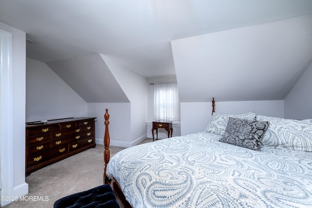 bedroom with lofted ceiling, carpet, and baseboards