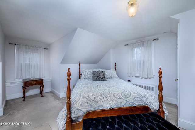 bedroom featuring carpet floors, radiator heating unit, baseboards, and vaulted ceiling