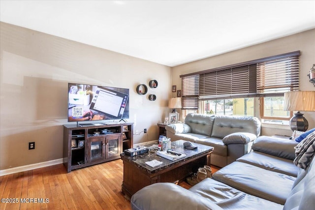 living area with light wood-style flooring and baseboards