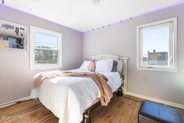 bedroom featuring wood finished floors and baseboards