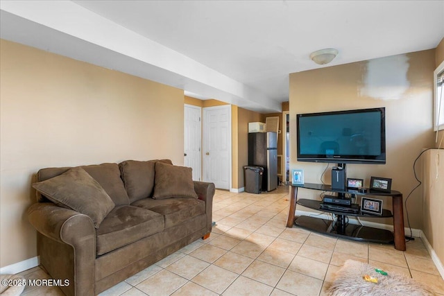 living area with light tile patterned floors and baseboards