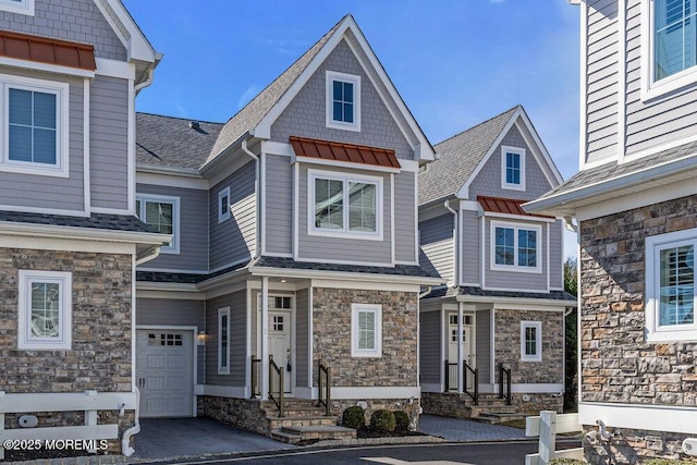 view of front of home with driveway and a shingled roof