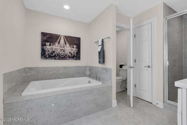 bathroom featuring toilet, marble finish floor, a shower stall, and a bath