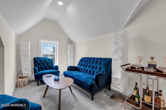 living area featuring carpet floors, baseboards, and vaulted ceiling