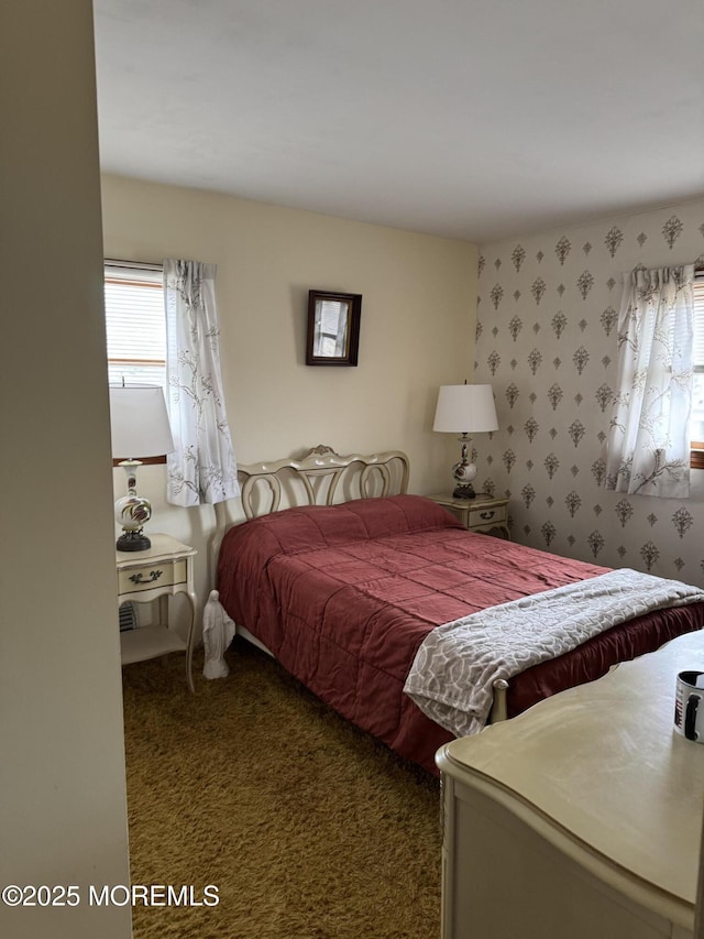 carpeted bedroom with multiple windows and wallpapered walls