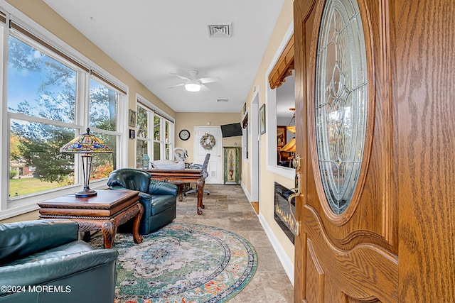 interior space featuring baseboards, visible vents, and a ceiling fan