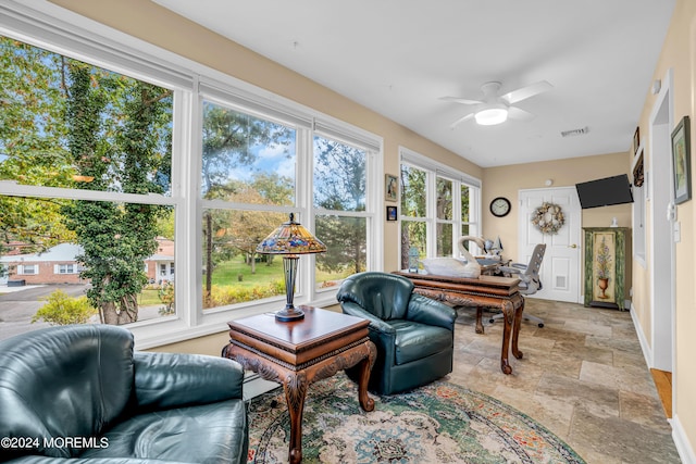 sunroom / solarium with visible vents and ceiling fan