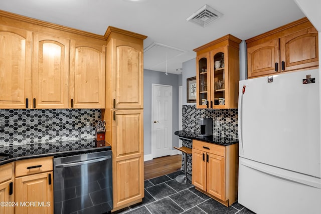 kitchen featuring dark countertops, visible vents, glass insert cabinets, freestanding refrigerator, and dishwasher