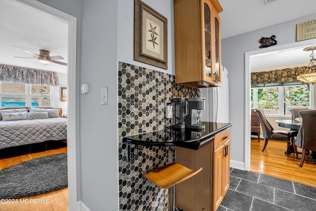 kitchen with dark countertops, decorative backsplash, a wealth of natural light, and open floor plan