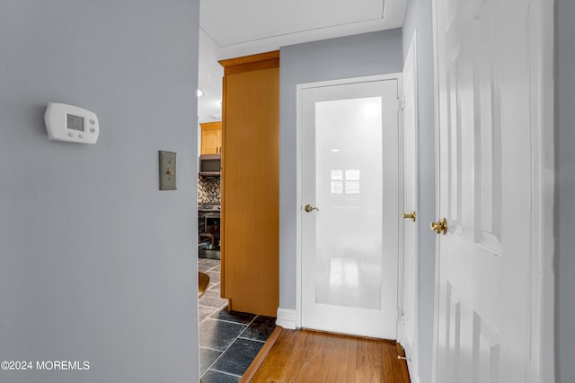 corridor featuring wood finished floors