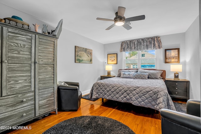 bedroom featuring ceiling fan, wood finished floors, and baseboards