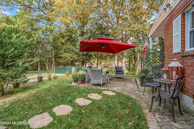 view of yard with fence and a patio