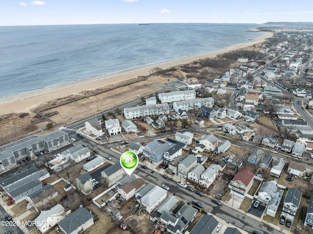 aerial view with a water view, a residential view, and a view of the beach