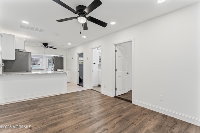 unfurnished living room featuring recessed lighting, visible vents, ceiling fan, light wood-type flooring, and baseboards