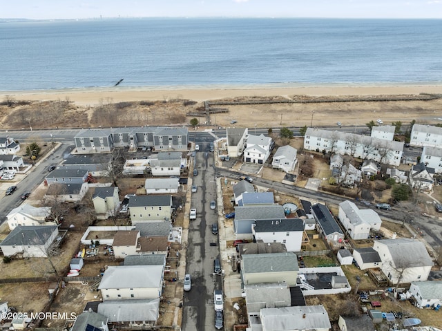 birds eye view of property with a residential view, a water view, and a beach view