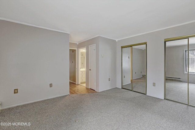 unfurnished bedroom featuring baseboards, multiple closets, ornamental molding, baseboard heating, and carpet