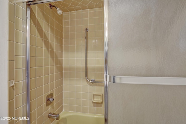 bathroom featuring shower / bath combination with glass door